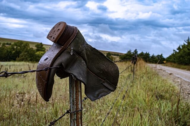 A boot hung on a fencepost