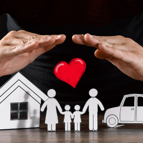 paper cut out of a home a car and a family with human hands above them protecting all of them