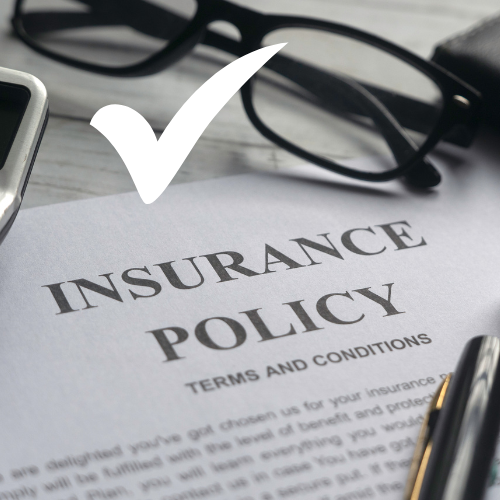 insurance policy sitting on a desk with a checkmark in white