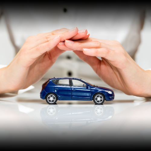 Toy car on a table with woman's hands cupped protectively above it, symbolizing the comprehensive protection offered by car insurance coverage options in Montana